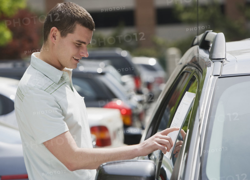 Man looking at new car.