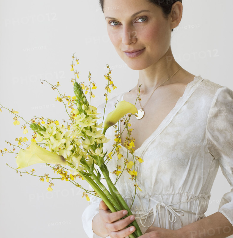 Woman holding bouquet of flowers.