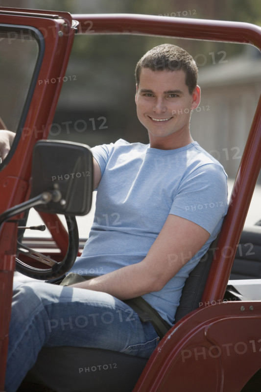 Man sitting in jeep.