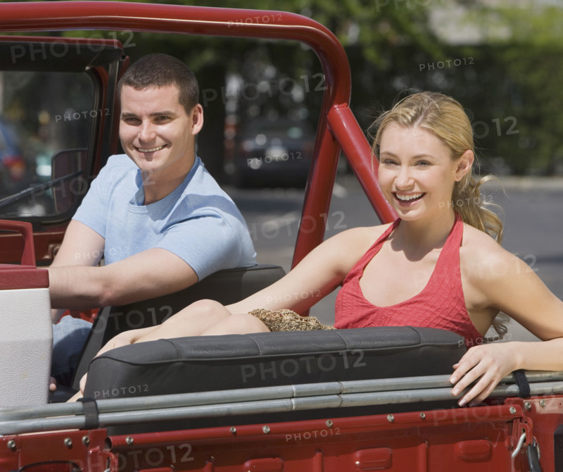 Couple sitting in jeep.