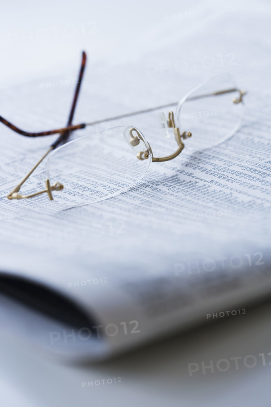 Eyeglasses on newspaper.