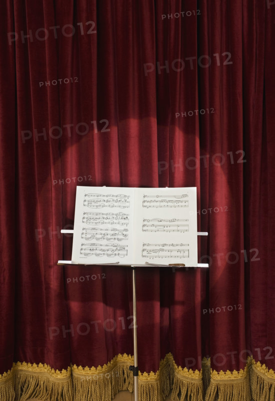 Spotlight on sheet music on stage.