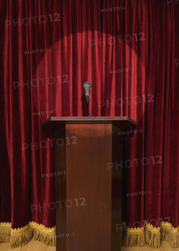 Spotlight on podium on stage.