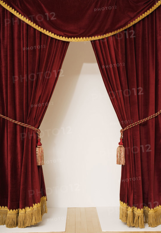 Screen behind open stage curtains.