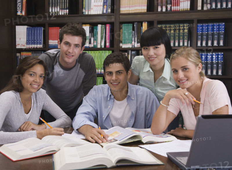 College students studying in library.