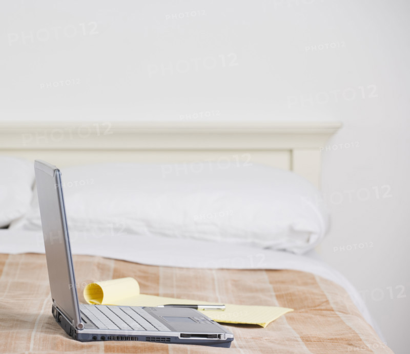 Still life of laptop computer on bed. Date : 2006
