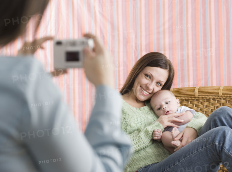 Mother and baby having their photograph taken. Date : 2006
