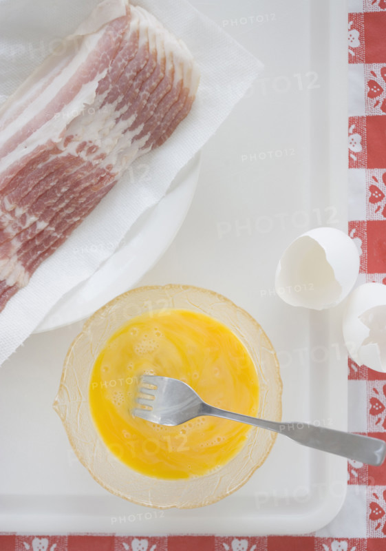 High angle view of raw bacon and eggs. Date : 2006