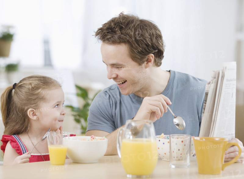 Father and daughter eating breakfast. Date : 2007