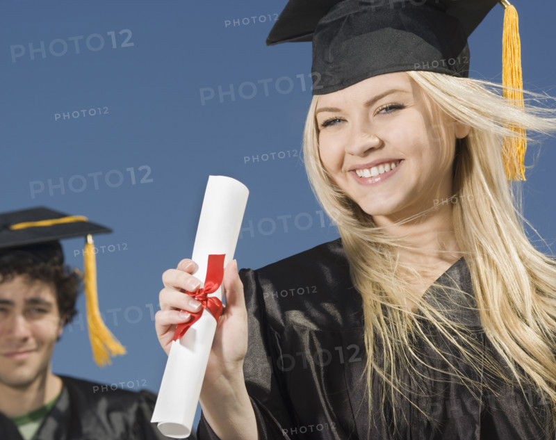 Woman wearing graduation cap and gown with diploma. Date : 2007