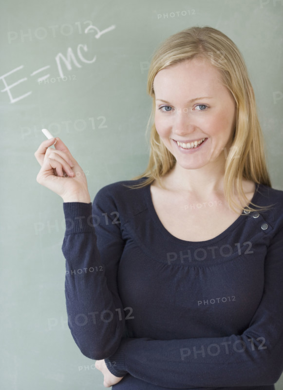 Woman standing in front of blackboard. Date : 2007