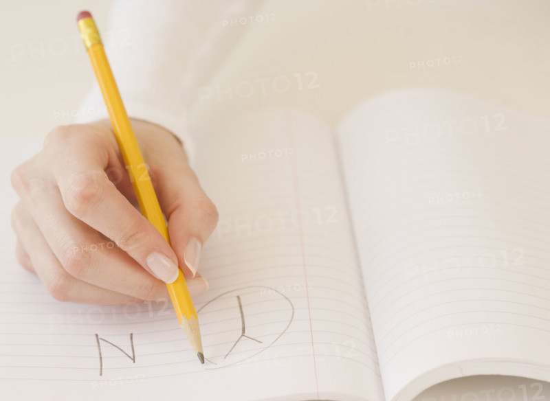 Woman circling the letter Y in notebook. Date : 2007