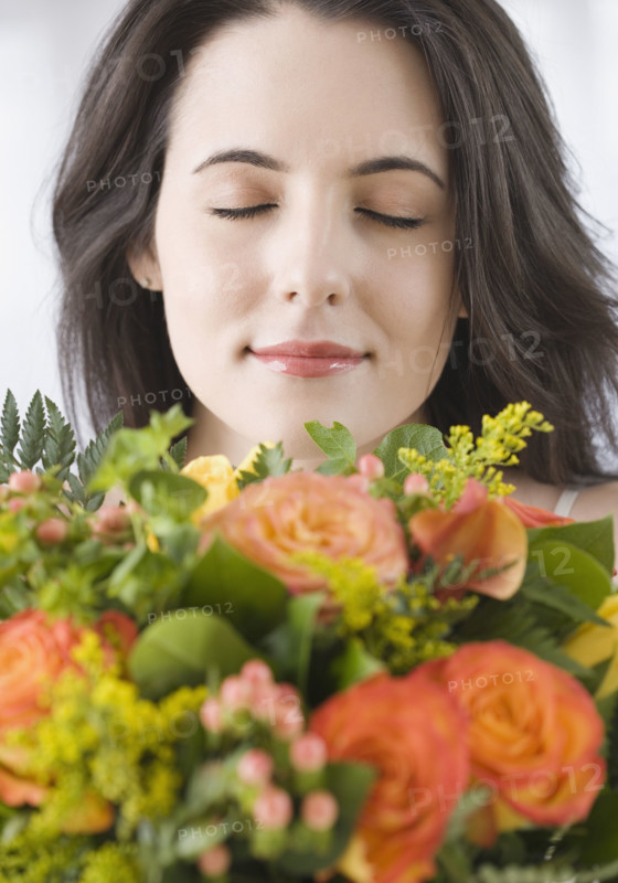 Woman smelling bouquet of flowers. Date : 2007
