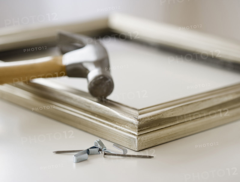 Close up of hammer, nails and picture frame. Date : 2006