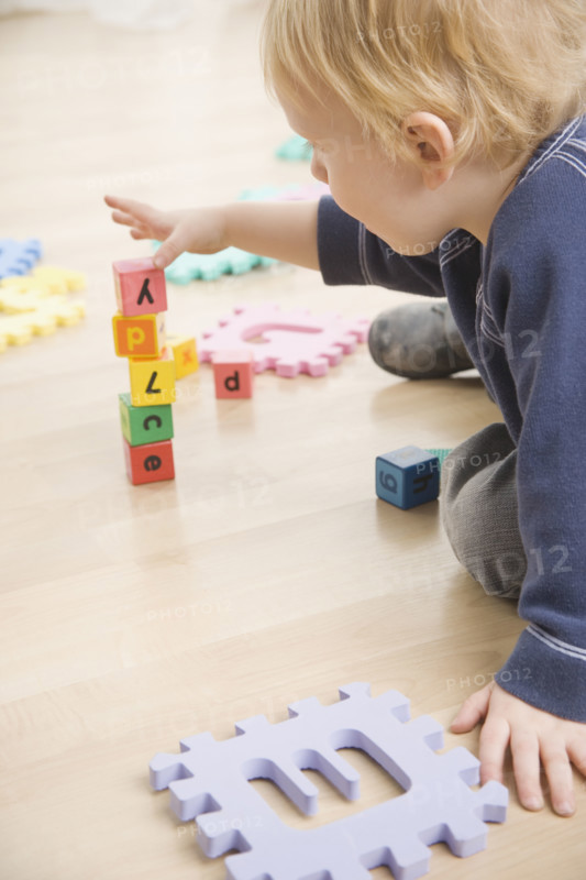 Toddler stacking blocks. Date : 2006