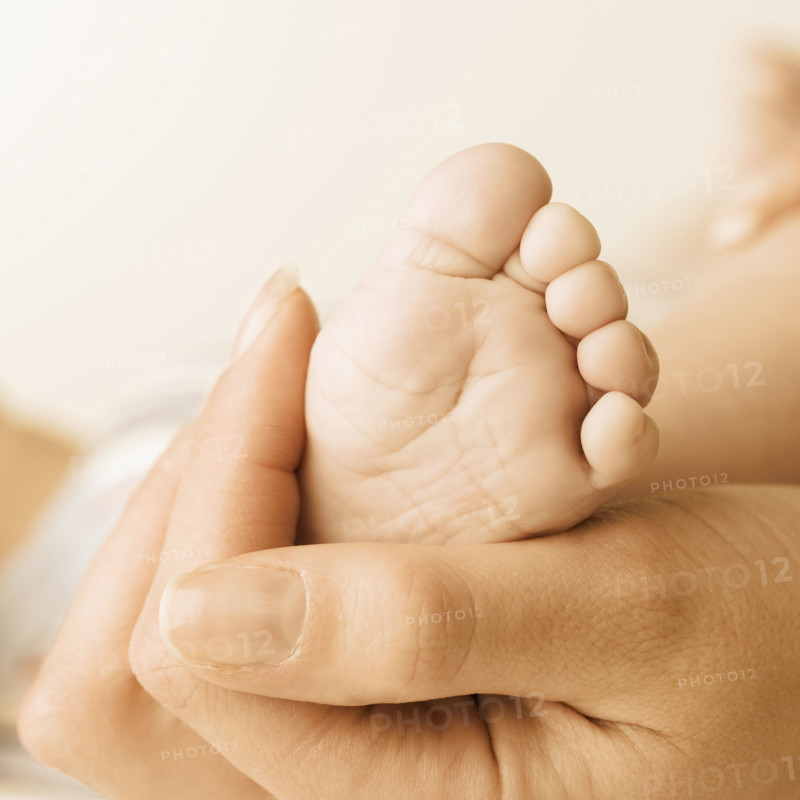 Close up of baby’s foot in mother’s hand. Date : 2006