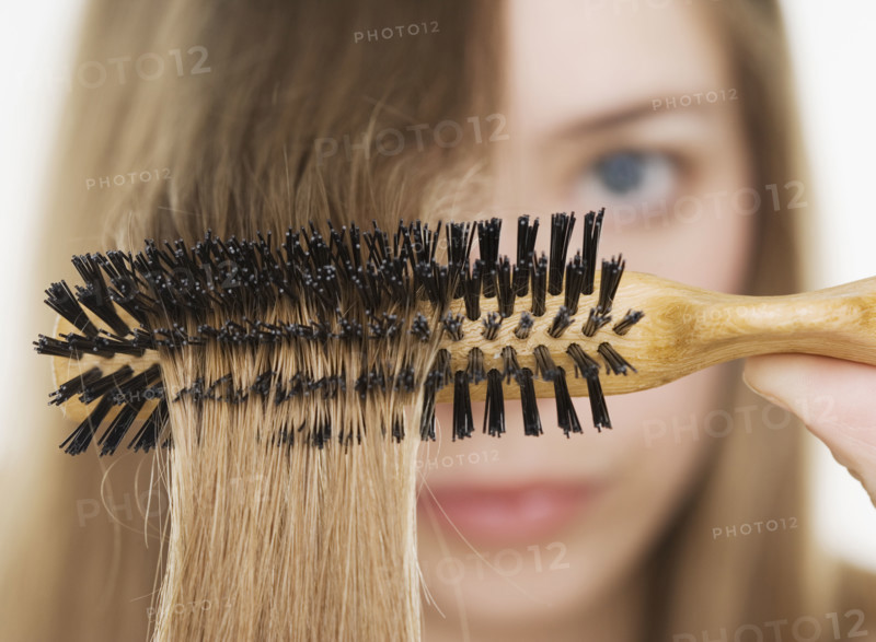 Close up of hairbrush in woman’s hair. Date : 2006
