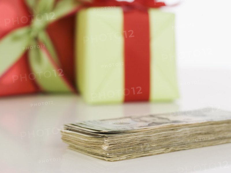 Studio shot of pile of money and gifts. Date : 2006
