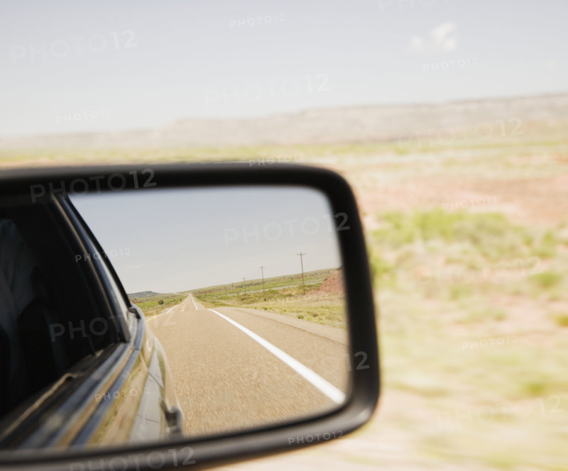 Road reflected in car side mirror. Date : 2006