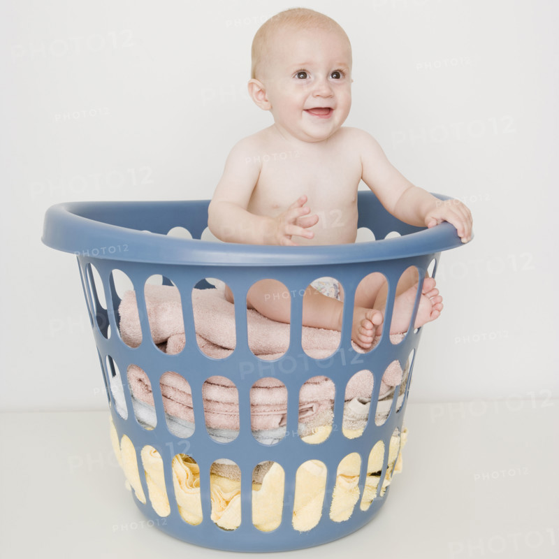 Baby sitting in laundry basket. Date : 2007