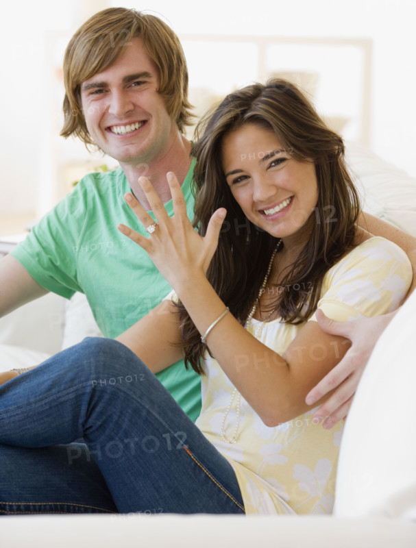 Engaged couple showing off engagement ring. Date : 2007