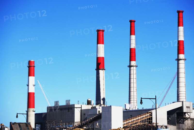 Factory with smoke stacks under blue sky. Date : 2007