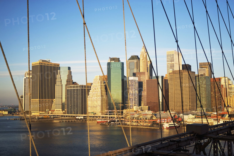 View of skyline through Brooklyn Bridge, New York City. Date : 2007