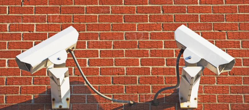 Security cameras on brick wall. Date : 2007
