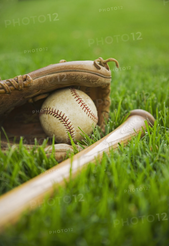 Baseball equipment laying on grass. Date : 2006