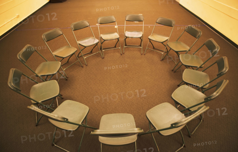 Empty folding chairs in circle. Date : 2007
