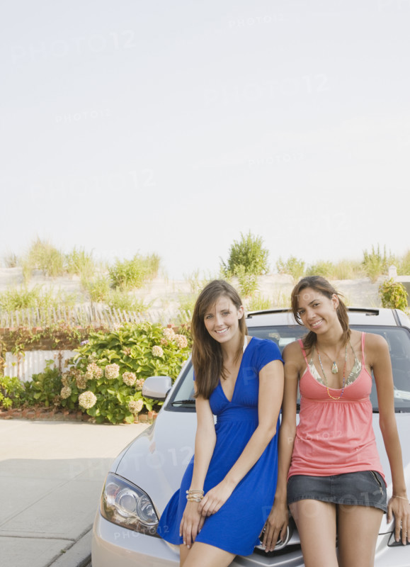 Young women sitting on car. Date : 2007