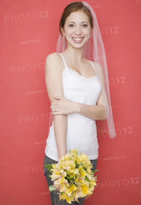 Woman wearing bridal veil and holding flowers. Date : 2007