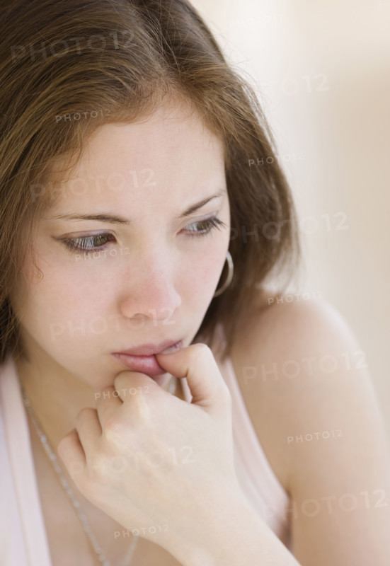 Close up of woman biting thumb. Date : 2007