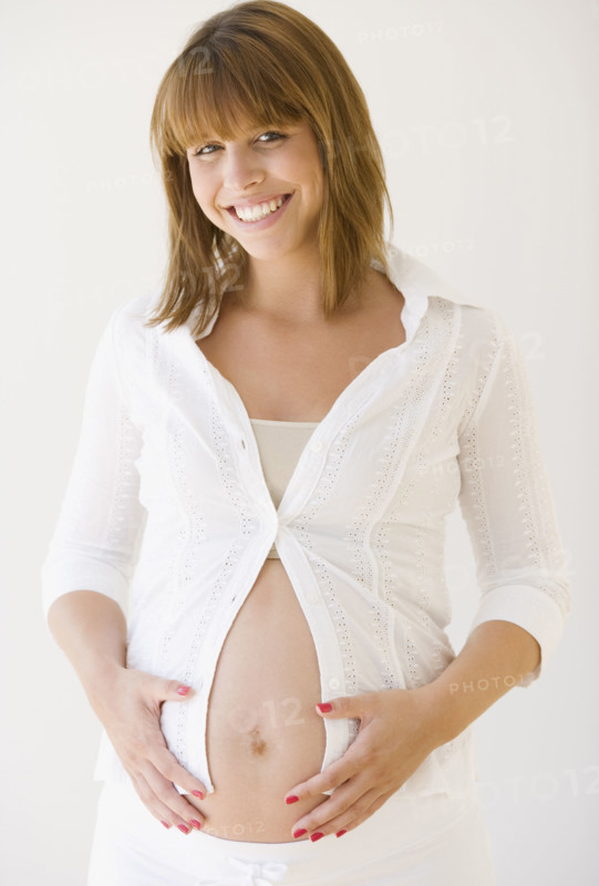 Pregnant woman with hands on belly. Date : 2007