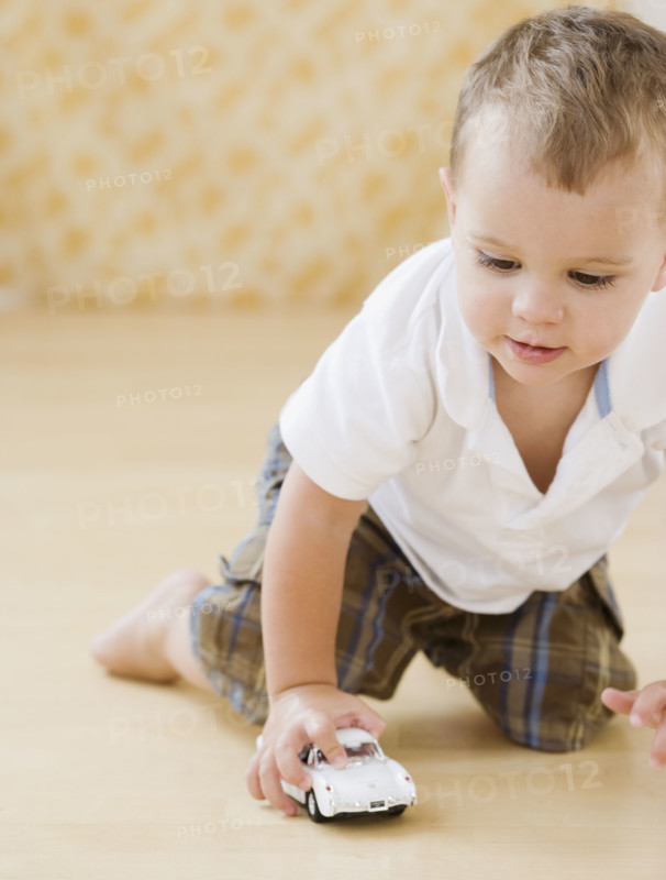 Baby playing with toy car. Date : 2007