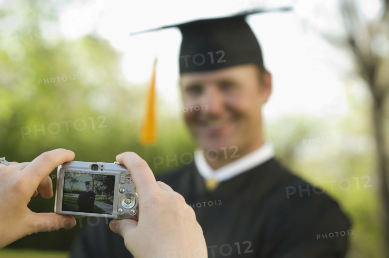 Male graduate having photograph taken. Date : 2007