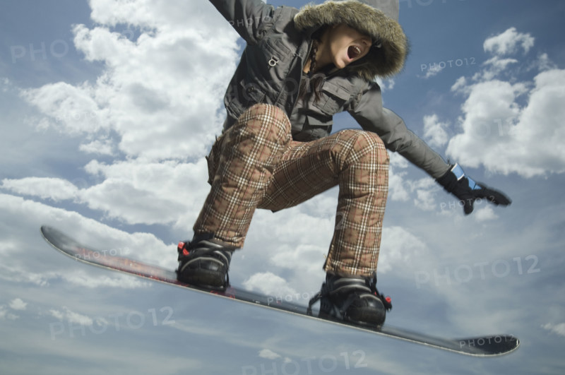 Low angle view of snowboarder jumping. Date : 2007