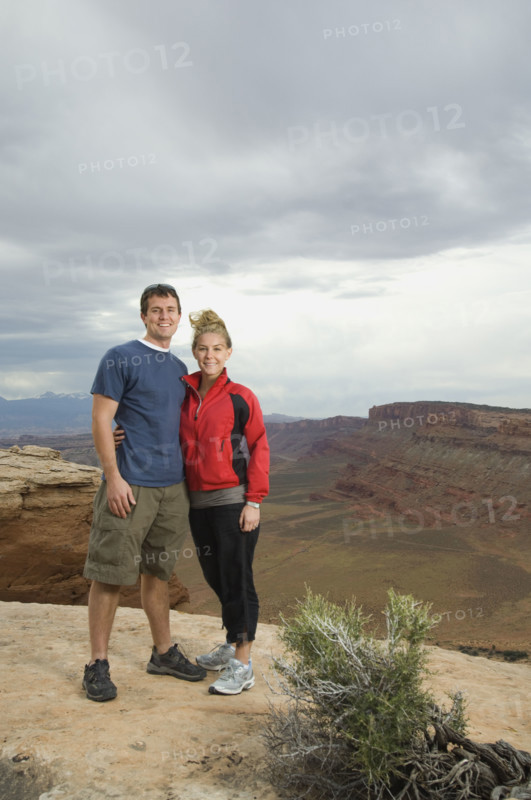 Couple standing at edge of cliff. Date : 2007