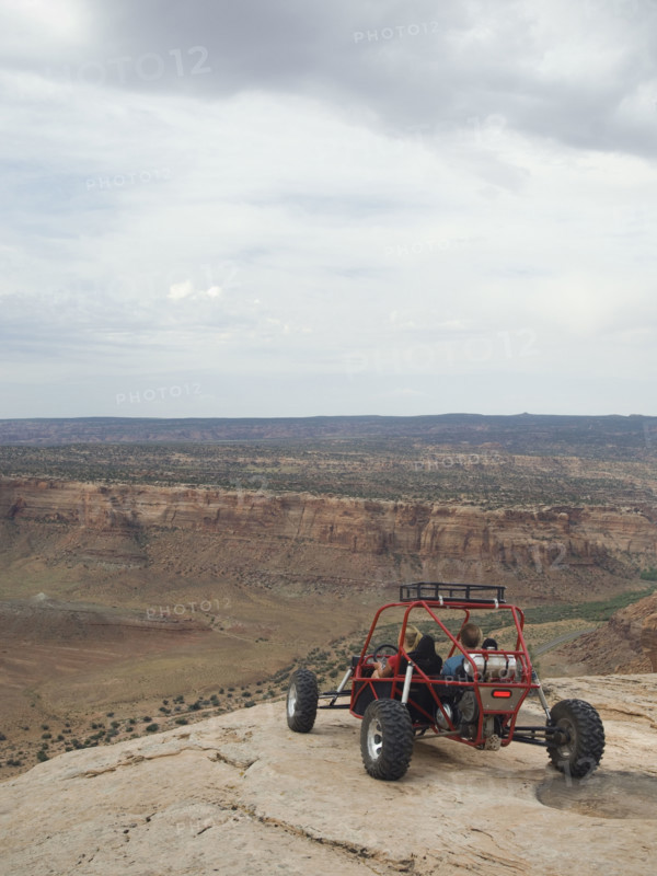 People in off-road vehicle at edge of cliff. Date : 2007