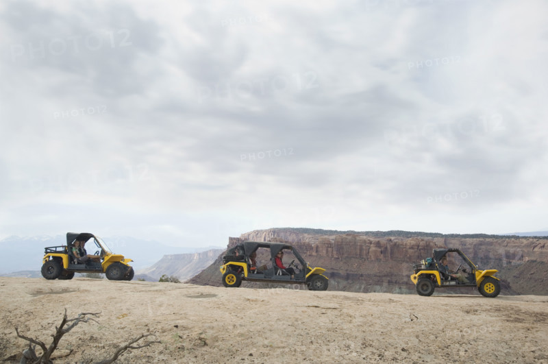 People in off-road vehicles on rock formation. Date : 2007