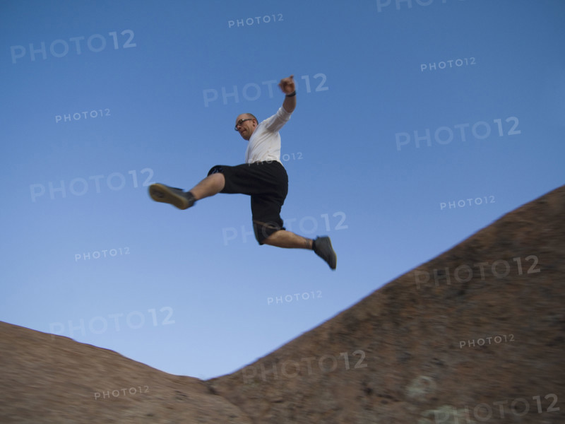 Man jumping over rock formations. Date : 2007
