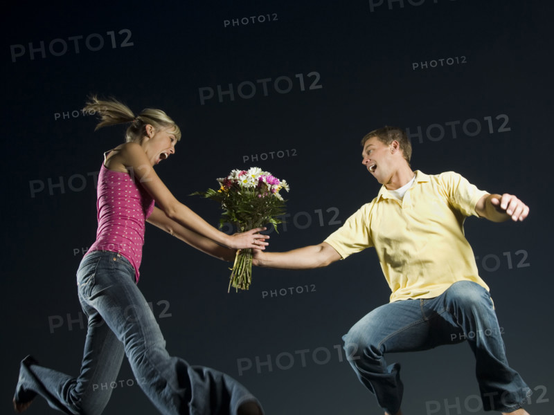 Couple jumping and holding flowers. Date : 2007