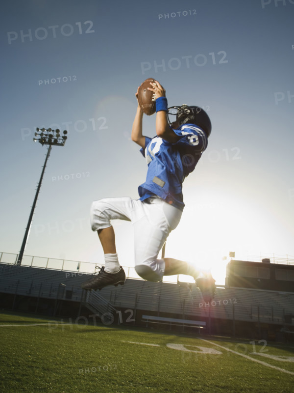 Young football player catching ball. Date : 2007