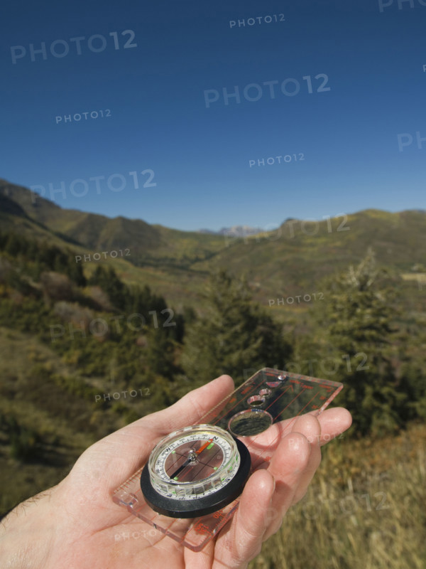 Close up of man holding compass, Utah, United States. Date : 2007