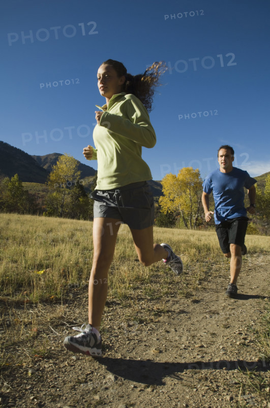 Couple jogging on trail, Utah, United States. Date : 2007
