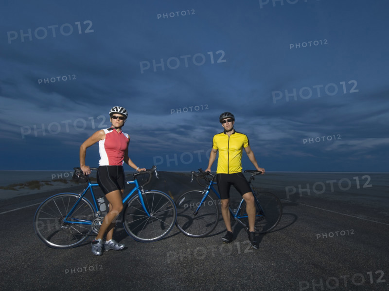 Couple with bicycles on road, Utah, United States. Date : 2007