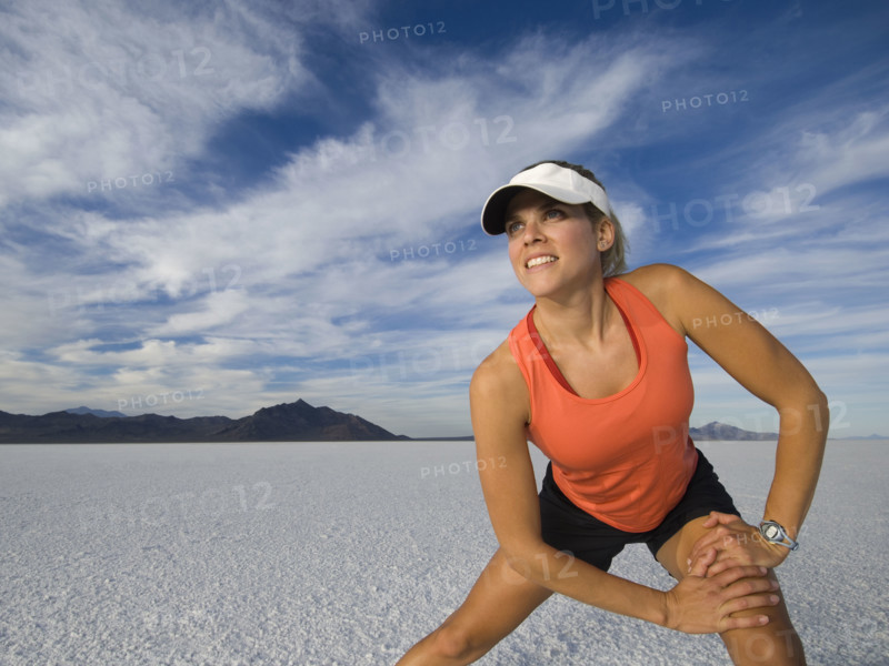 Woman stretching at salt flats, Utah, United States. Date : 2007