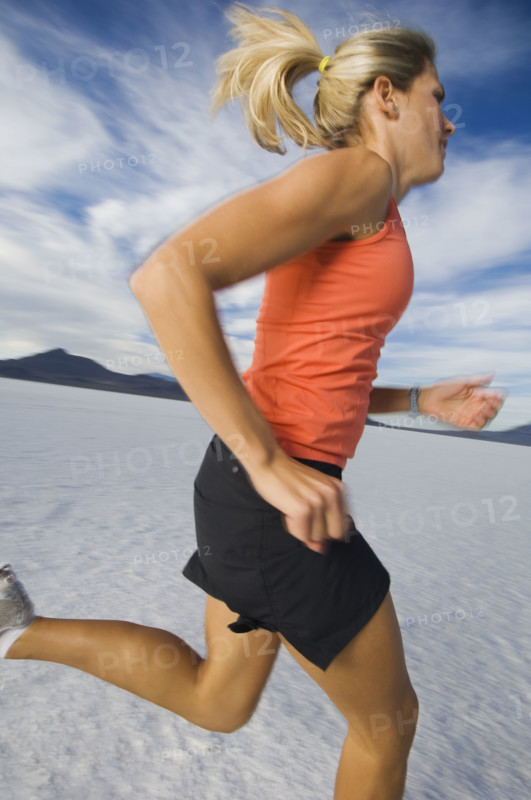 Woman running on salt flats, Utah, United States. Date : 2007