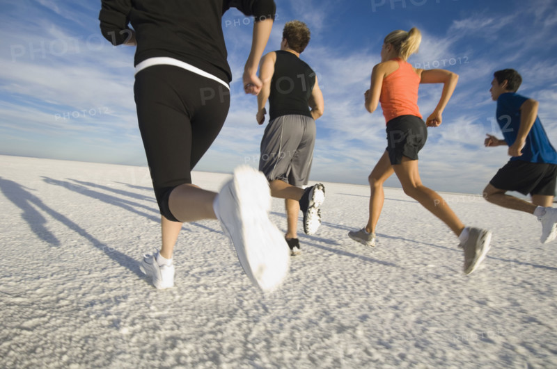 Group of people running on salt flats, Utah, United States. Date : 2007