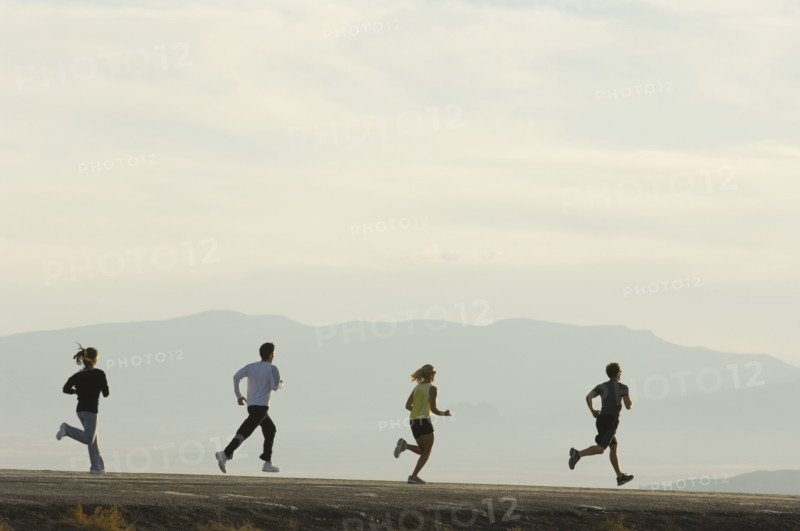 Group of people running on road, Utah, United States. Date : 2007